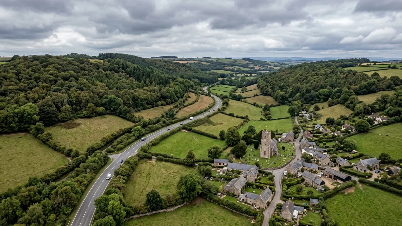A main road running east through the wooded slopes and hedged fields of the Blackdown Hills on the Devon and Somerset border