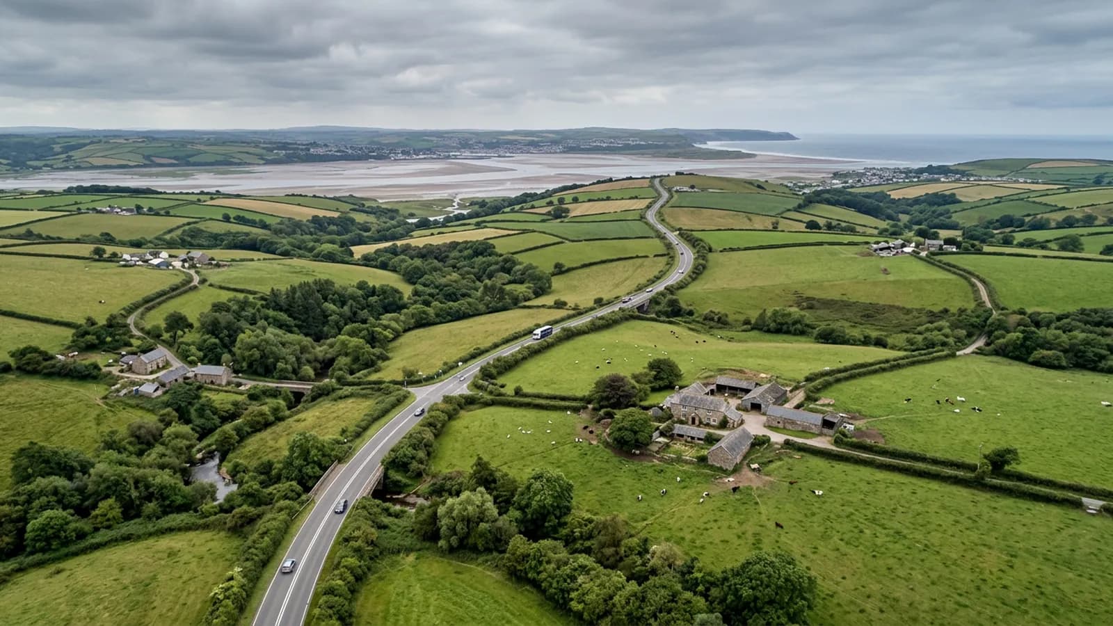 A link road crossing rolling North Devon farmland towards the Taw estuary with the coast in the far distance